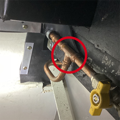 Example of a prohibited press-fit fitting used in an installation on a food truck.
