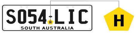 A yellow pentagon tag with the letter 'H' inserted in the middle of a SA number plate